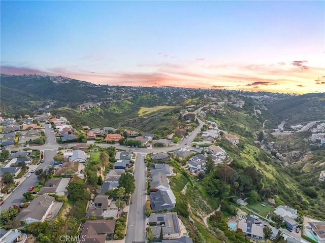 aerial view at dusk with a residential view and a mountain view