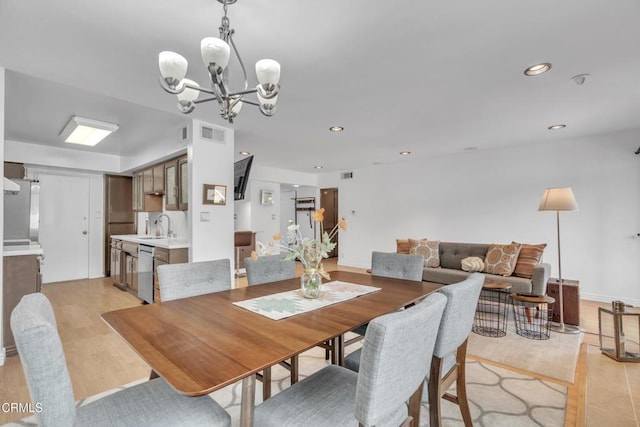 dining area featuring light wood-style floors, recessed lighting, a chandelier, and visible vents