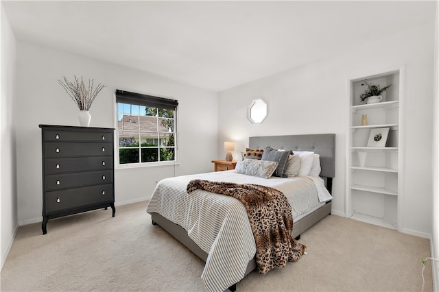 bedroom featuring baseboards and light carpet