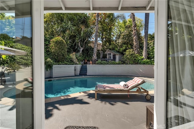 view of swimming pool with fence, a fenced in pool, and a patio area