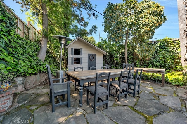 view of patio / terrace featuring an outdoor structure, central AC unit, and outdoor dining space