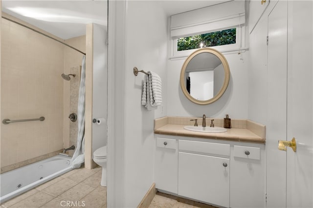 full bathroom featuring toilet, baseboards, a combined bath / shower with jetted tub, and vanity