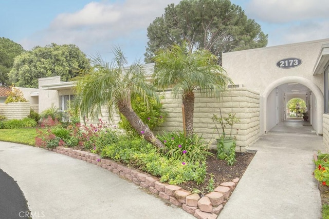 exterior space featuring fence and stucco siding