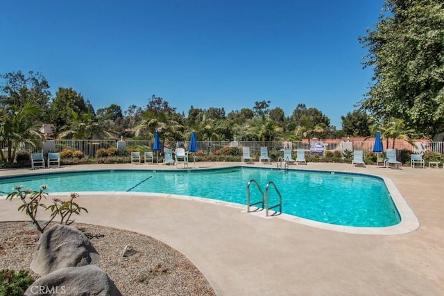 pool featuring a patio area and fence
