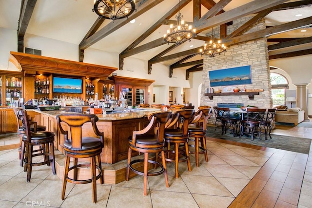 bar featuring beam ceiling, high vaulted ceiling, indoor wet bar, a notable chandelier, and recessed lighting