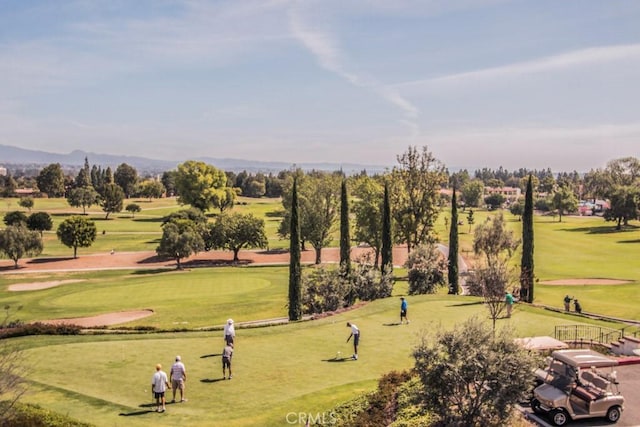 surrounding community featuring a yard and golf course view