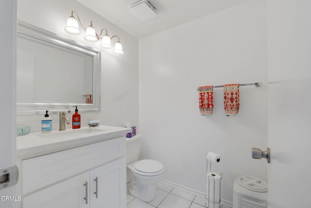 bathroom featuring vanity, tile patterned floors, and toilet