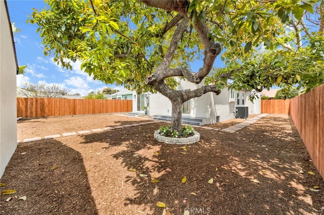 view of yard featuring a fenced backyard and cooling unit
