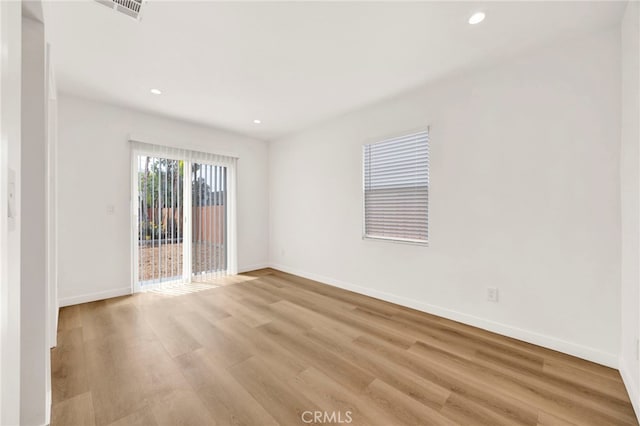 spare room featuring recessed lighting, baseboards, and light wood-style floors