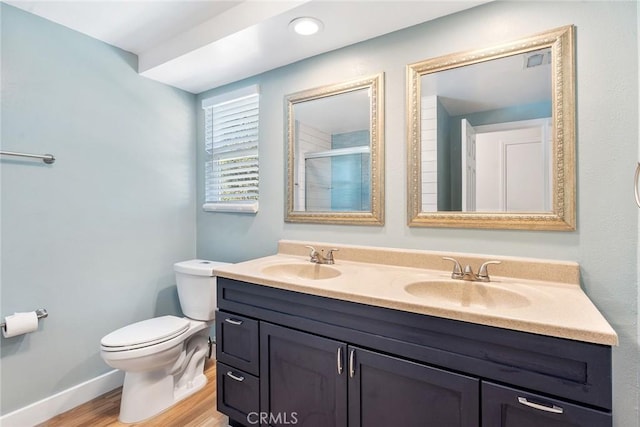 23341 Bessemer St, Woodland Hills, CA 91367 - full bathroom with a sink, a shower with shower door, toilet, and wood finished floors