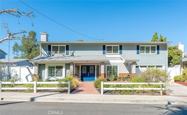23341 Bessemer St, Woodland Hills, CA 91367 - traditional home with french doors, a chimney, a fenced front yard, and brick siding