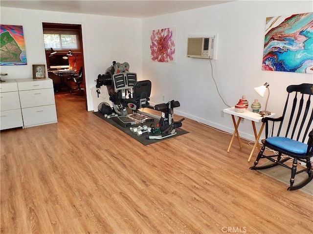 interior space with a wall unit AC and light wood-type flooring