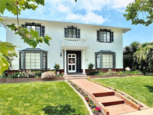 3835 California Ave, Long Beach, CA 90807 - view of front of house featuring stucco siding, a front lawn, a balcony, and brick siding
