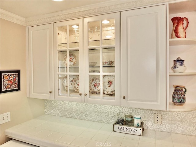 3835 California Ave, Long Beach, CA 90807 - detailed view of white cabinetry, glass insert cabinets, ornamental molding, and tile counters