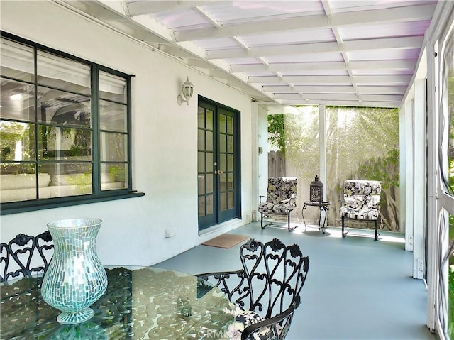 sunroom with concrete floors and french doors