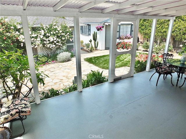 unfurnished sunroom with beamed ceiling