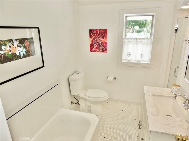 3835 California Ave, Long Beach, CA 90807 - bathroom with vanity, a tub to relax in, baseboards, and toilet