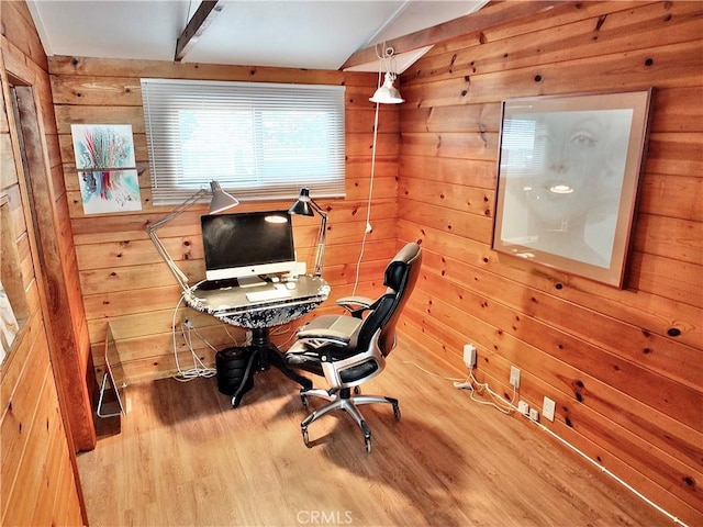 home office featuring vaulted ceiling, wood walls, and wood finished floors