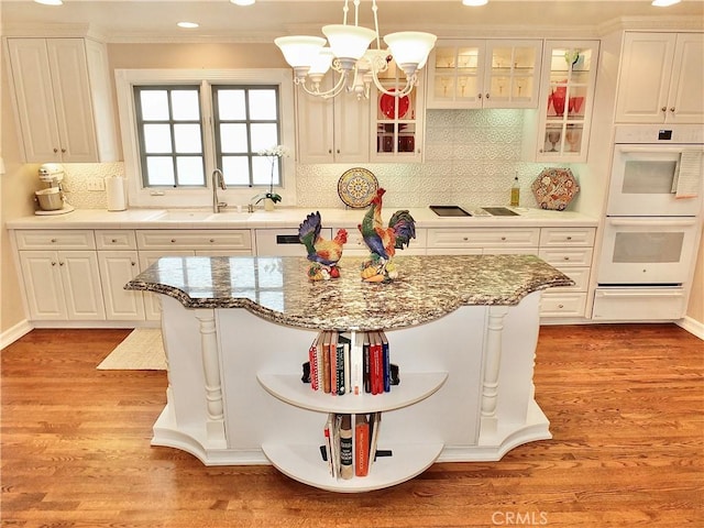 3835 California Ave, Long Beach, CA 90807 - kitchen featuring double oven, a warming drawer, a chandelier, white cabinets, and a sink