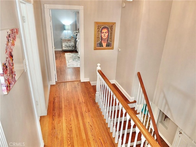 3835 California Ave, Long Beach, CA 90807 - corridor featuring light wood-style floors, an upstairs landing, and baseboards