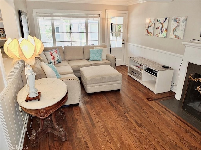 3835 California Ave, Long Beach, CA 90807 - living area featuring dark wood-style floors, ornamental molding, wainscoting, and a fireplace with flush hearth