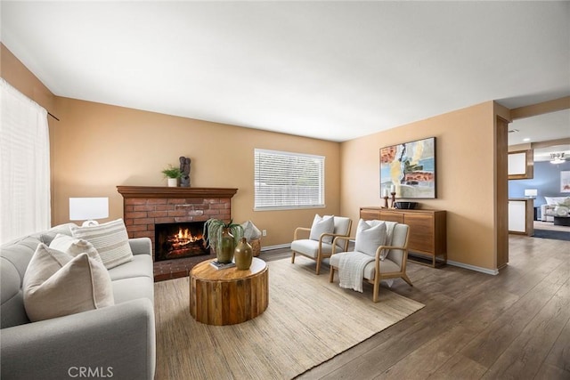 3881 Valle Vista Dr, Chino Hills, CA 91709 - living room with a brick fireplace, wood-type flooring, and baseboards