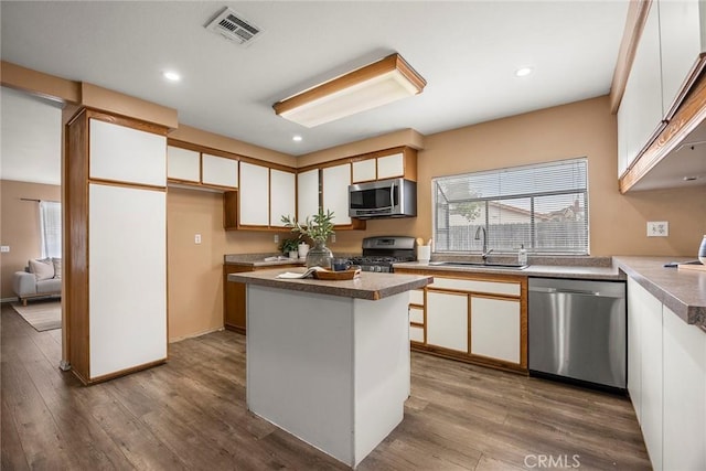 3881 Valle Vista Dr, Chino Hills, CA 91709 - kitchen with stainless steel appliances, a sink, healthy amount of natural light, white cabinets, and recessed lighting