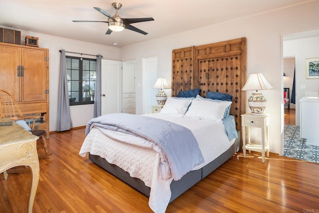bedroom featuring a ceiling fan and wood finished floors