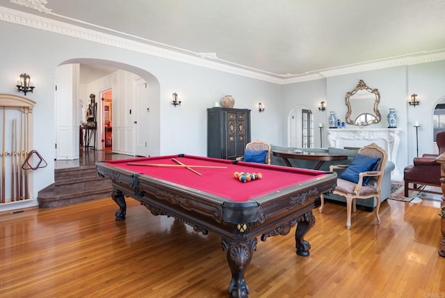 recreation room with crown molding, arched walkways, billiards, and wood finished floors