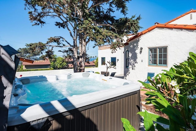 view of pool with a hot tub