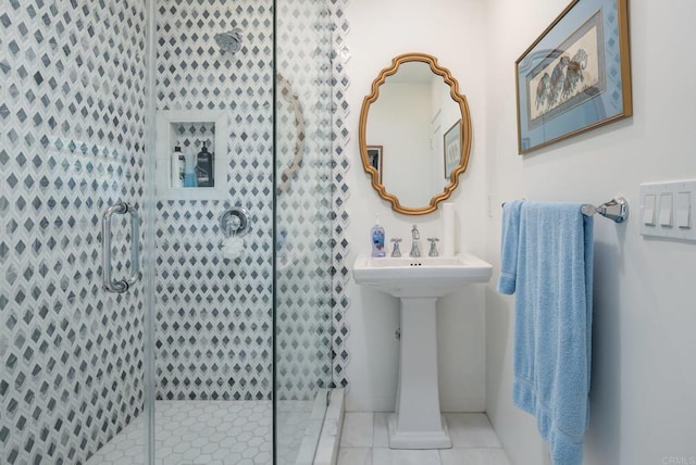 full bath with tile patterned floors and a tile shower