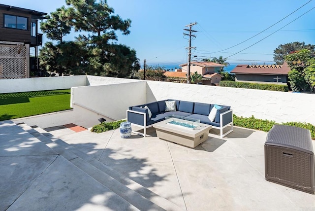 view of patio featuring a fenced backyard and an outdoor living space with a fire pit