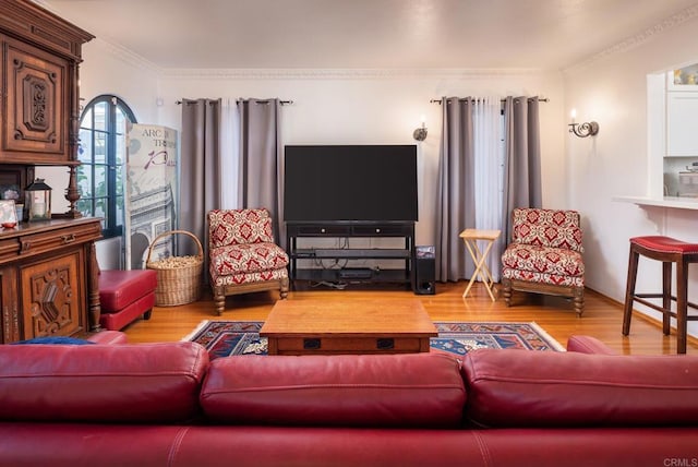 living area featuring crown molding and wood finished floors