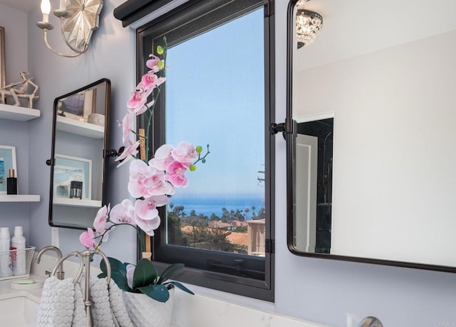 interior details featuring a sink and a water view