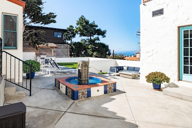 view of patio with fence, entry steps, and an outdoor fire pit