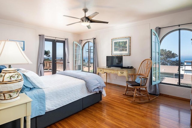 bedroom with wood finished floors, access to exterior, baseboards, french doors, and a ceiling fan