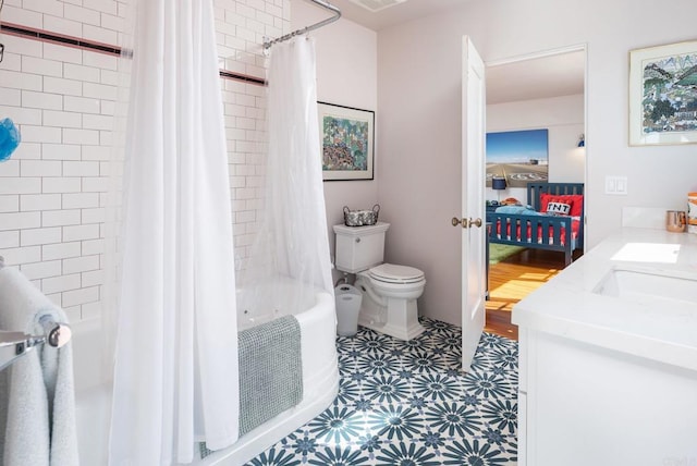 ensuite bathroom featuring shower / bath combo with shower curtain, vanity, toilet, connected bathroom, and tile patterned floors
