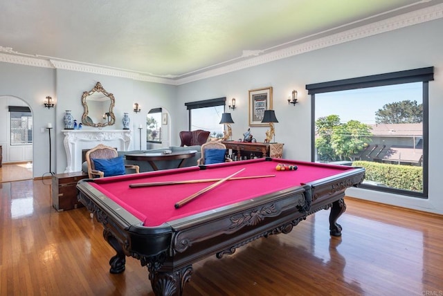 playroom featuring pool table, ornamental molding, arched walkways, and wood finished floors