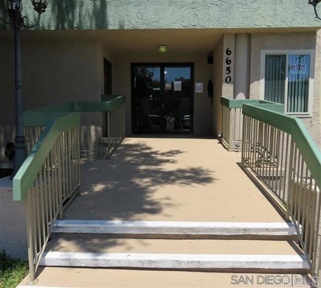 doorway to property featuring stucco siding