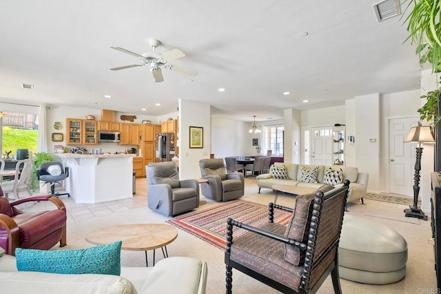 living room featuring recessed lighting, visible vents, plenty of natural light, and light tile patterned floors