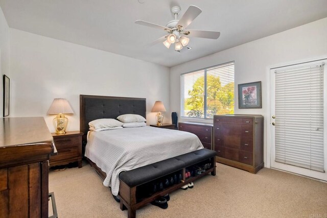 bedroom featuring a ceiling fan and light carpet