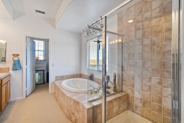 full bath with a stall shower, visible vents, a bath, and vanity