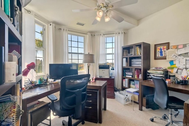office featuring visible vents, a ceiling fan, and light colored carpet