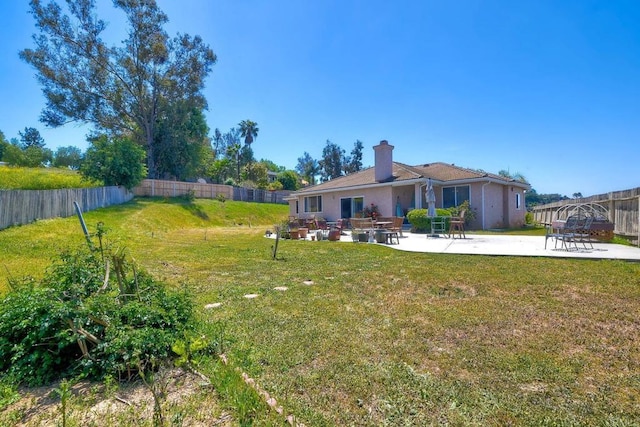 view of yard featuring fence and a patio area