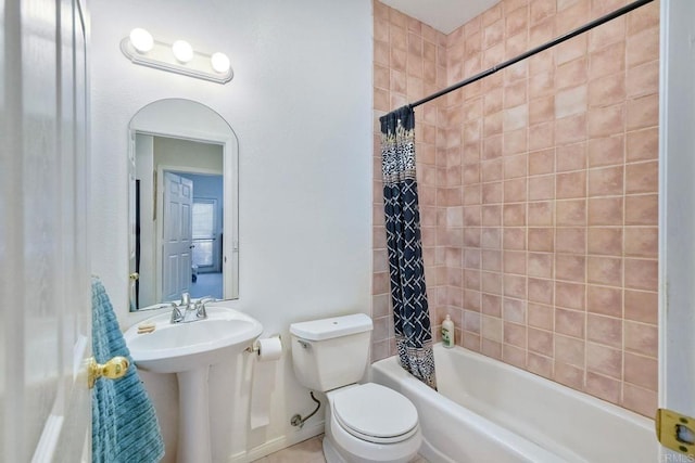 bathroom with a sink, toilet, and shower / tub combo