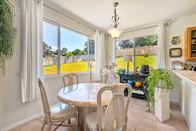 dining area featuring baseboards and light tile patterned floors