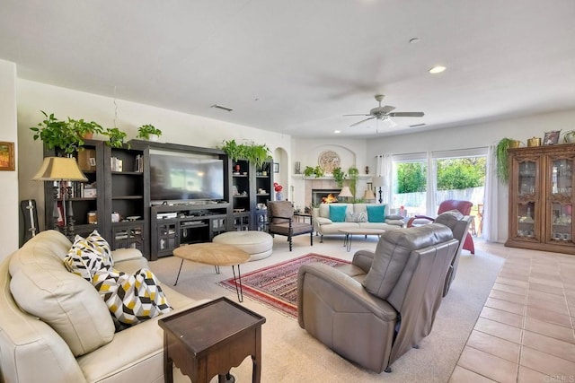 living area with ceiling fan, visible vents, a fireplace, tile patterned floors, and recessed lighting