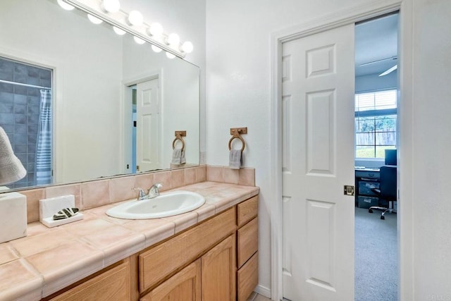 bathroom featuring vanity and curtained shower