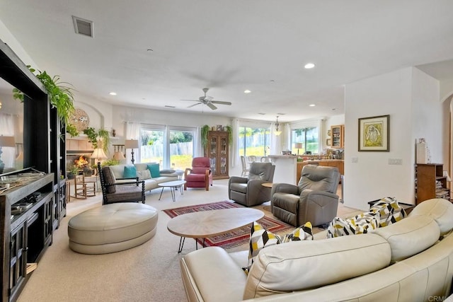 living area featuring a ceiling fan, recessed lighting, light carpet, and visible vents