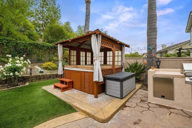 1752 Cottonwood Dr, Vista, CA 92081 - view of patio featuring a fenced backyard, an outdoor kitchen, a gazebo, and a hot tub